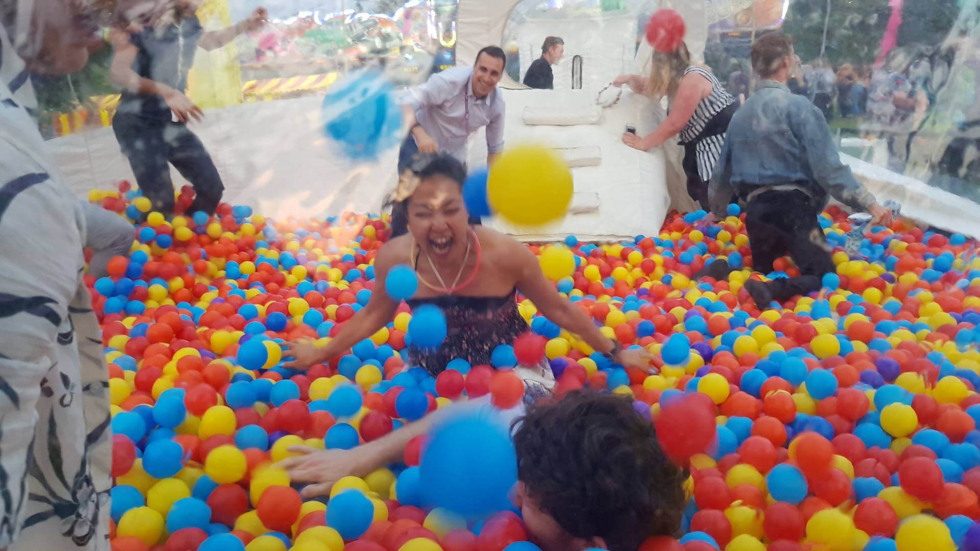 people playing in ball pit