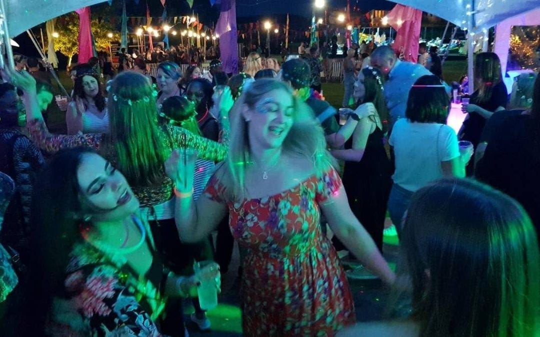 group of girls dancing at party with lights