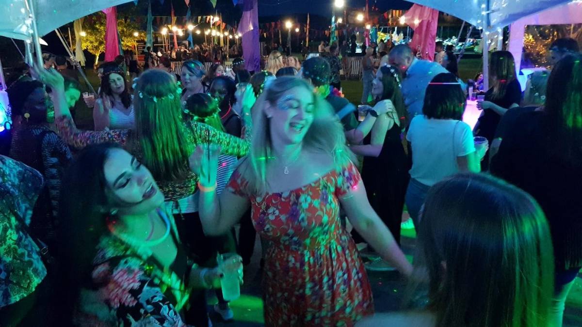 group of girls dancing at party with lights